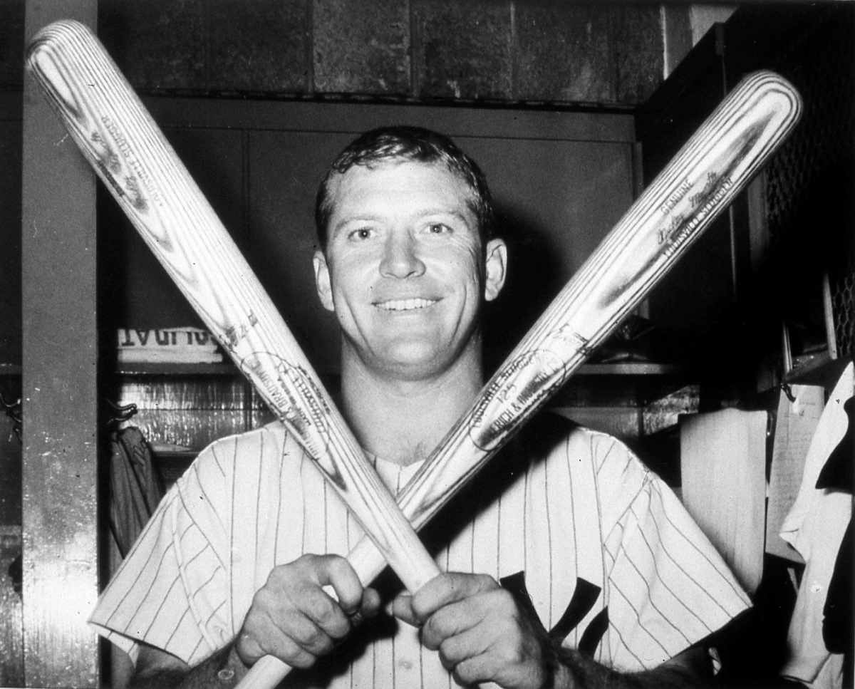 Black and white photograph of Mickey Mantle, legendary New York Yankees outfielder, holding a bat before a game.