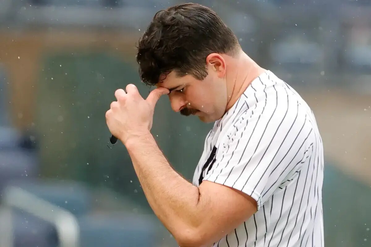 Carlos Rodon walks off the field after being taken out of a game by New York Yankees manager Aaron Boone.